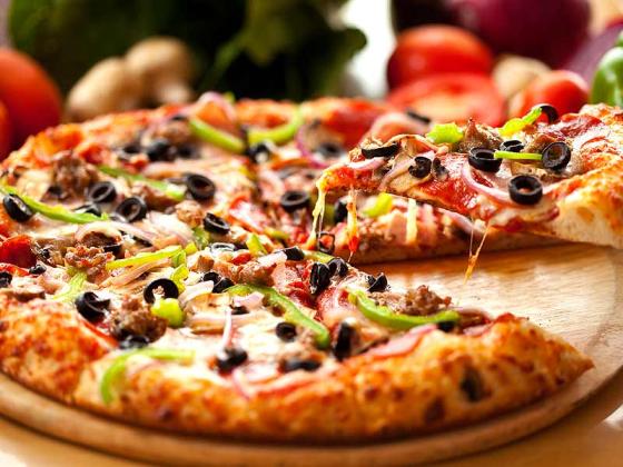 Supreme pizza slices with olives and peppers